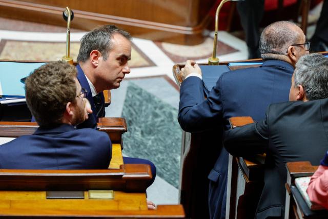 France's Prime Minister Sebastien Lecornu (L) looks on during a session of questions to the government at The National Assembly, France's lower house of parliament in Paris on April 8, 2026. (Photo by GEOFFROY VAN DER HASSELT / AFP)