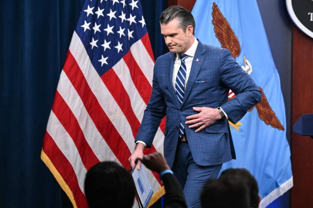 US Secretary of Defense Pete Hegseth departs after speaking during a press briefing at the Pentagon in Washington, DC, on April 8, 2026. The United States and Iran agreed to a two-week ceasefire on April 7 barely an hour before President Donald Trump's deadline to obliterate the country, triggering global relief alongside apprehension. Tehran has agreed to temporarily reopen the Strait of Hormuz, through which much of the world's oil, gas and fertiliser passes, easing concerns for the battered global economy. (Photo by Mandel NGAN / AFP)