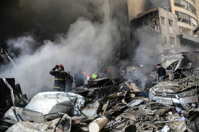 First responders and residents stand amid rubble at the site of an Israeli airstrike in Beirut's Corniche al-Mazraa neighbourhood on April 8, 2026. Israel launched a series of strikes in Beirut on April 8, causing panic among residents in the most violent attack on the capital since the start of the war with Hezbollah. The Israeli military said it carried out its "largest coordinated strike across Lebanon". Israel has insisted the two-week truce in its war with Iran does not apply to Lebanon. (Photo by Ibrahim AMRO / AFP)