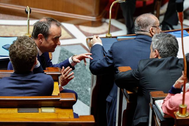France's Prime Minister Sebastien Lecornu (L) and France's Justice Minister Gerald Darmanin discuss during a session of questions to the government at The National Assembly, France's lower house of parliament in Paris on April 8, 2026. (Photo by GEOFFROY VAN DER HASSELT / AFP)