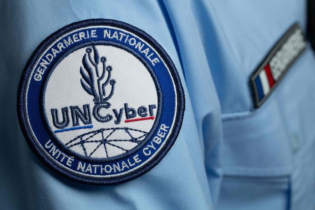 This photograph shows the badge on a uniform of a police officer from the National Cyber Unit (Unite Nationale Cyber, UNCyber) of the National Gendarmerie in Pontoise on April 7, 2026. (Photo by Joel Saget / AFP)