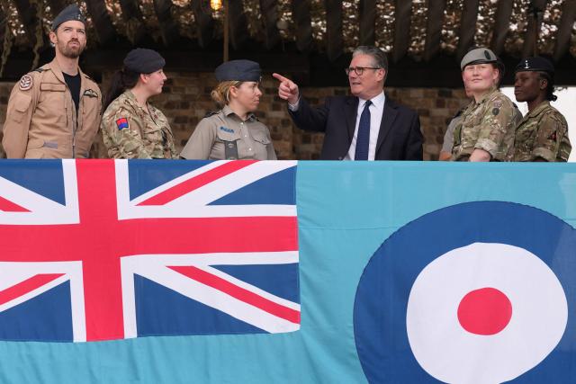 Britain's Prime Minister Keir Starmer (3rd R) points as he meets aircrew members during a visit to Taif Airbase, Saudi Arabia, on April 8, 2026. British Prime Minister Keir Starmer arrived on April 9 in Saudi Arabia, on the first stop of a Gulf tour aimed at bolstering the ceasefire in the Middle East war, Downing Street said. (Photo by Alastair Grant / POOL / AFP)