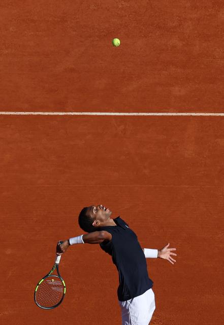 Canada's Felix Auger-Aliassime serves to Croatia's Marin Cilic during the Monte Carlo ATP Masters Series Tournament round of 32 tennis match on Court Rainier III at the Monte-Carlo Country Club in Roquebrune-Cap-Martin, south-eastern France on April 8, 2026. (Photo by Valery HACHE / AFP)