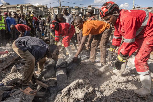 Kenya Red Cross members and volunteers search through a rubble where a building collapsed, killing three people and injuring several others, at the Nyayo high-rise, Soweto village in Kibera, Nairobi on April 8, 2026. (Photo by SIMON MAINA / AFP)