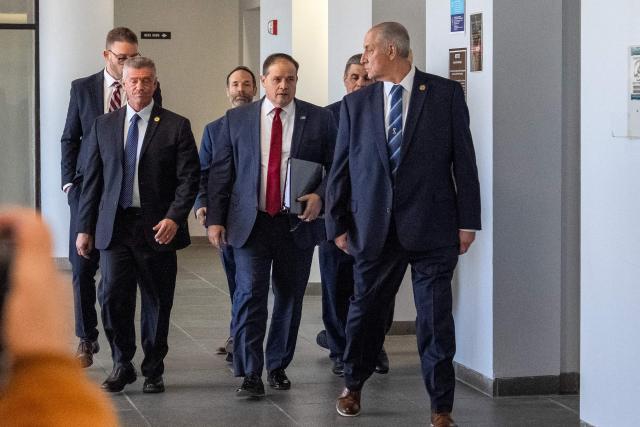 Suffolk County District Attorney Raymond A. Tierney (C) arrives at the Suffolk County Court for a scheduled court appearance by Rex Heuermann in connection with the Gilgo Beach serial killings, in Riverhead, New York on April 8, 2026. The Gilgo Beach serial killings refer to a series of murders discovered on Long Island in 2010–2011, with Rex Heuermann arrested in 2023 and charged in several of the killings. (Photo by David Dee Delgado / AFP)