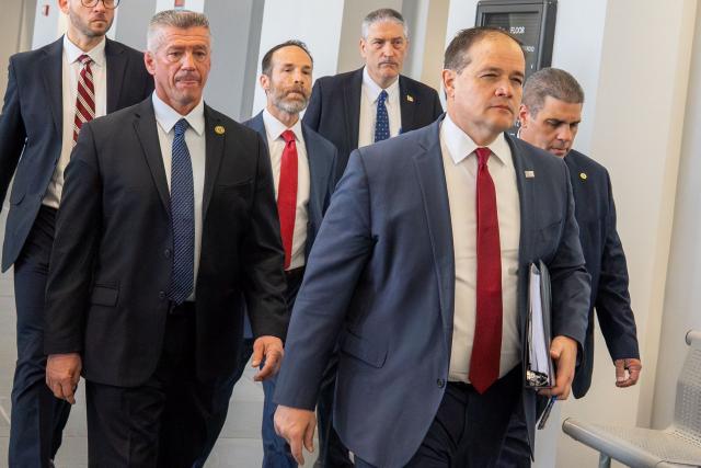Suffolk County District Attorney Raymond A. Tierney (2R) arrives at the Suffolk County Court for a scheduled court appearance by Rex Heuermann in connection with the Gilgo Beach serial killings, in Riverhead, New York on April 8, 2026. The Gilgo Beach serial killings refer to a series of murders discovered on Long Island in 2010–2011, with Rex Heuermann arrested in 2023 and charged in several of the killings. (Photo by David Dee Delgado / AFP)