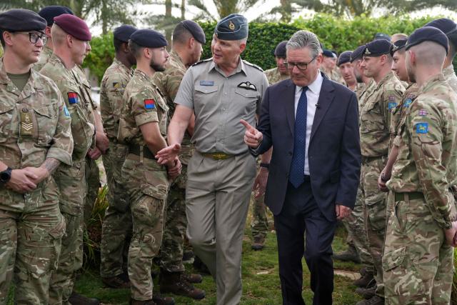 Britain's Prime Minister Keir Starmer (centre R) is lead by Air Vice Marshall Jez Attridge (C) during a visit to Taif Airbase, Saudi Arabia, on April 8, 2026. British Prime Minister Keir Starmer arrived on April 9 in Saudi Arabia, on the first stop of a Gulf tour aimed at bolstering the ceasefire in the Middle East war, Downing Street said. (Photo by Alastair Grant / POOL / AFP)