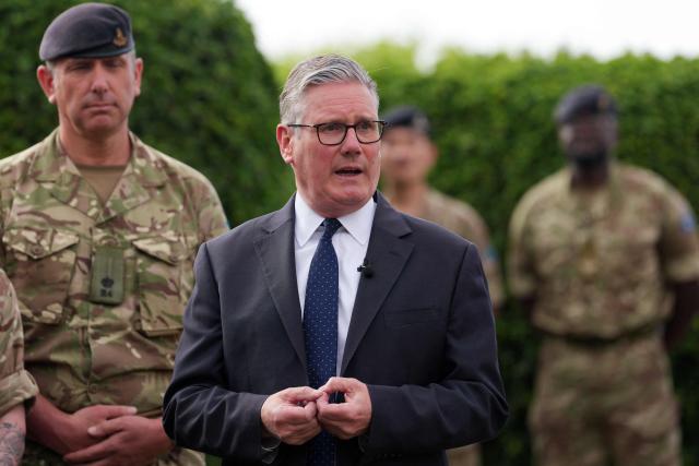 Britain's Prime Minister Keir Starmer (C) meets aircrew members during a visit to Taif Airbase, Saudi Arabia, on April 8, 2026. British Prime Minister Keir Starmer arrived on April 9 in Saudi Arabia, on the first stop of a Gulf tour aimed at bolstering the ceasefire in the Middle East war, Downing Street said. (Photo by Alastair Grant / POOL / AFP)
