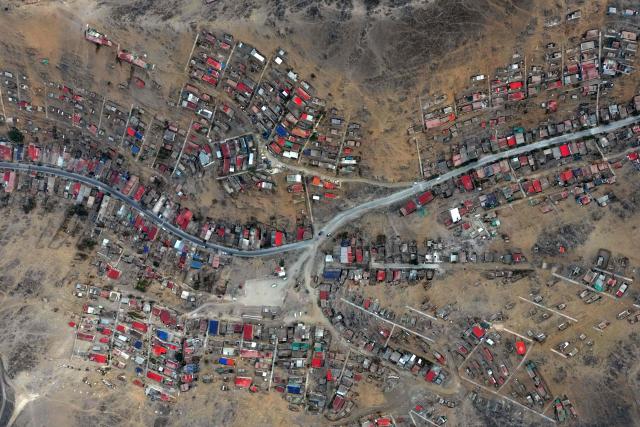Aerial view of the Villa Maria del Triunfo neighborhood in Lima, on April 8, 2026. Peruvians will choose from a bewildering array of 35 presidential candidates on April 12, 2026, electing the next leader of an Andean nation beset by crime and a string of short-lived, scandal tainted presidencies. (Photo by Luis ROBAYO / AFP)