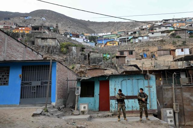 Police officers stand guard on a street in the Villa Maria del Triunfo neighborhood in Lima, on April 8, 2026. Peruvians will choose from a bewildering array of 35 presidential candidates on April 12, 2026, electing the next leader of an Andean nation beset by crime and a string of short-lived, scandal tainted presidencies. (Photo by Luis ROBAYO / AFP)