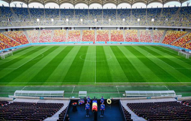Honor guard soldiers stand next to the coffin of Romanian football legend Mircea Lucescu as it is laid in state at the National Arena in Bucharest, Romania, April 8, 2026. Fans and figures from the sporting world gathered at the country's largest stadium to pay their final respects to the former national team coach and one of the most decorated managers in history, who passed away on April 7, 2026, at the age of 80. (Photo by Daniel MIHAILESCU / AFP)