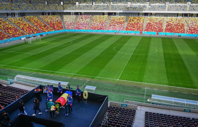 Honor guard soldiers stand next to the coffin of Romanian football legend Mircea Lucescu as it is laid in state at the National Arena in Bucharest, Romania, April 8, 2026. Fans and figures from the sporting world gathered at the country's largest stadium to pay their final respects to the former national team coach and one of the most decorated managers in history, who passed away on April 7, 2026, at the age of 80. (Photo by Daniel MIHAILESCU / AFP)