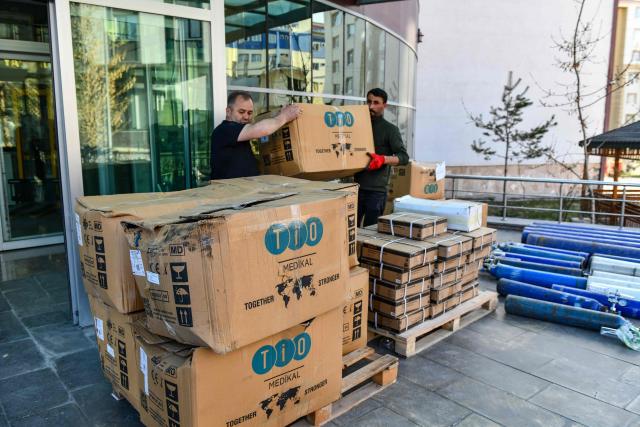 Workers handle medical cardboard boxes as Turkish Health Ministry plans to send medical supplies in Iran in Van, north-eastern Turkey, on April 8, 2026. Three trucks loaded with humanitarian aid are scheduled to enter Iran on April 8, 2026 from Turkey, announced Turkish Health Minister Kemal Memisoglu. (Photo by Ali IHSAN OZTURK / AFP)