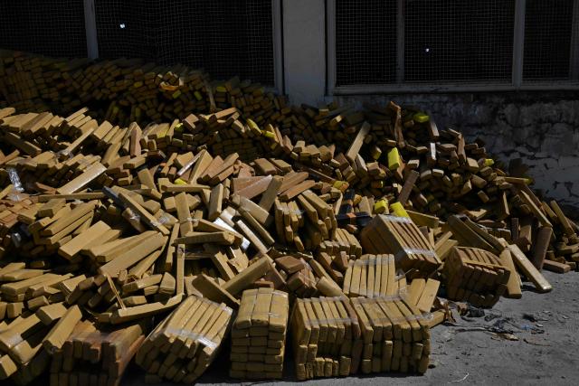 View of 48 tons of seized marijuana presented at the City of Police in Rio de Janeiro, Brazil on April 8, 2026, after they were uncovered by chance by a sniffer dog during a regular operation against criminal factions. During the operation in the Complexo da Mare, a large complex of favelas in the north of the city, a dog named Hulk indicated there was something suspicious under an abandoned water tank. An officer "discovered a bunker inside where this entire quantity of drugs had been hidden," said Lieutenant Colonel Luciano Pedro, commander of the Canine Operations Battalion. (Photo by Pablo PORCIUNCULA / AFP)