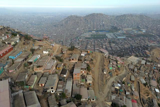 Aerial view of the Villa Maria del Triunfo neighborhood in Lima, on April 8, 2026. Peruvians will choose from a bewildering array of 35 presidential candidates on April 12, 2026, electing the next leader of an Andean nation beset by crime and a string of short-lived, scandal tainted presidencies. (Photo by Luis ROBAYO / AFP)