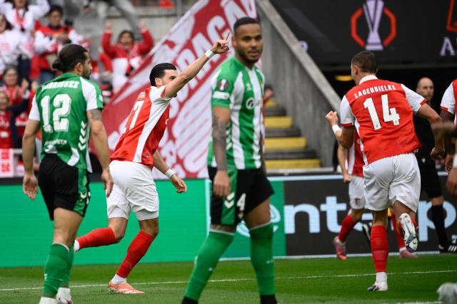 Sporting Braga's Austrian midfielder #27 Florian Grillitsch (2L) celebrates scoring his team's first goal during the UEFA Europa League quarter final first leg football match between SC Braga and Real Betis at Municipal stadium of Braga, on April 8, 2026. (Photo by Miguel RIOPA / AFP)