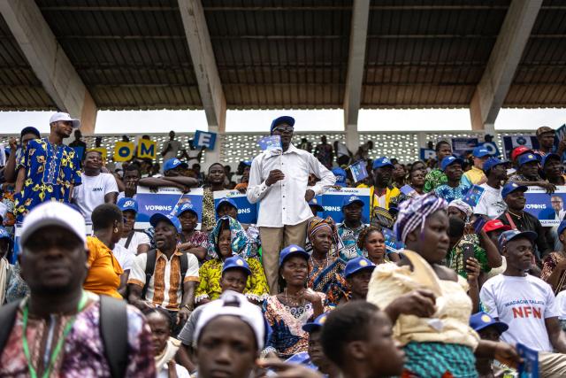 Supporters hold flags of presidential candidate Romuald Wadagni as they attend a campaign rally in Lokossa on April 8, 2026 ahead of Benin`s presidential election scheduled for April 12, 2026. (Photo by OLYMPIA DE MAISMONT / AFP)