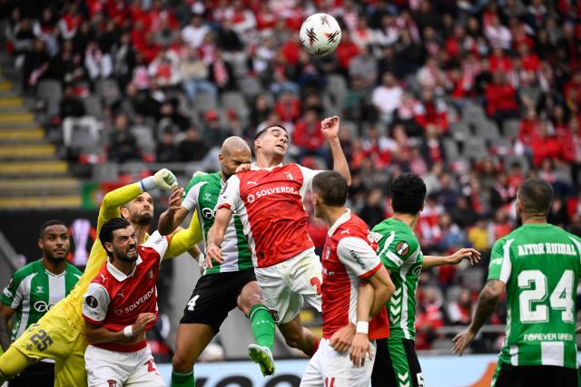 Real Betis' Moroccan midfielder #14 Sofyan Amrabat (C) and Sporting Braga's Spanish defender #02 Victor Gomez go for a header during the UEFA Europa League quarter final first leg football match between SC Braga and Real Betis at Municipal stadium of Braga, on April 8, 2026. (Photo by Miguel RIOPA / AFP)