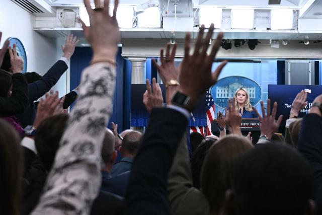 Reporters raise their hands to ask questions as White House Press Secretary Karoline Leavitt speaks during a press briefing in the Brady Briefing Room of the White House in Washington, DC, on April 8, 2026. (Photo by Brendan SMIALOWSKI / AFP)