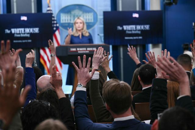 Reporters raise their hands to ask questions as White House Press Secretary Karoline Leavitt speaks during a press briefing in the Brady Briefing Room of the White House in Washington, DC, on April 8, 2026. (Photo by Brendan SMIALOWSKI / AFP)