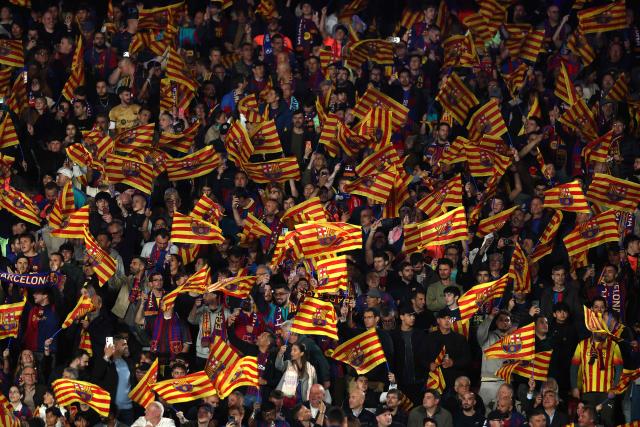 Barcelona's supporters wave flags prior the UEFA Champions League quarter final first leg football match between FC Barcelona and Club Atletico de Madrid at Camp Nou Stadium in Barcelona on April 8, 2026. (Photo by Josep LAGO / AFP)