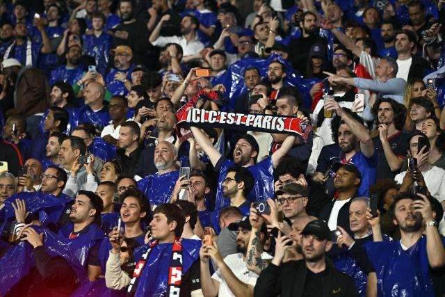Paris supporters cheer their team ahead of the UEFA Champions League quarter-final first leg football match between Paris Saint-Germain (PSG) and Liverpool FC at the Parc des Princes stadium in Paris on April 8, 2026. (Photo by JULIEN DE ROSA / AFP)