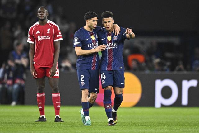 Paris Saint-Germain's French midfielder #14 Desire Doue (R) is congratulated by Paris Saint-Germain's Moroccan defender #02 Achraf Hakimi after scoring his team's first goal during the UEFA Champions League quarter-final first leg football match between Paris Saint-Germain (PSG) and Liverpool FC at the Parc des Princes stadium in Paris on April 8, 2026. (Photo by JULIEN DE ROSA / AFP)