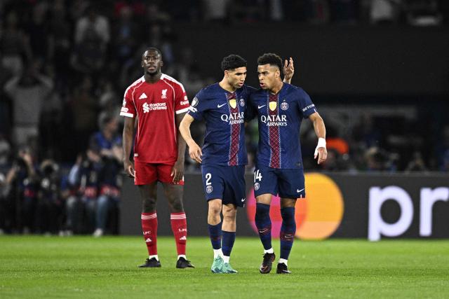 Paris Saint-Germain's French midfielder #14 Desire Doue (R) is congratulated by Paris Saint-Germain's Moroccan defender #02 Achraf Hakimi after scoring his team's first goal during the UEFA Champions League quarter-final first leg football match between Paris Saint-Germain (PSG) and Liverpool FC at the Parc des Princes stadium in Paris on April 8, 2026. (Photo by JULIEN DE ROSA / AFP)