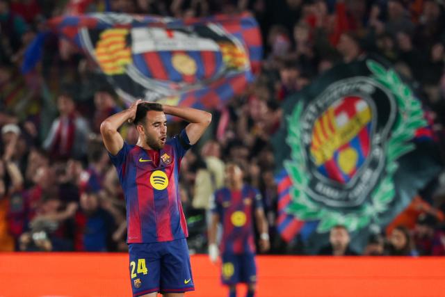 Barcelona's Spanish defender #24 Eric Garcia reacts after failing to score during the UEFA Champions League quarter final first leg football match between FC Barcelona and Club Atletico de Madrid at Camp Nou Stadium in Barcelona on April 8, 2026. (Photo by Lluis GENE / AFP)