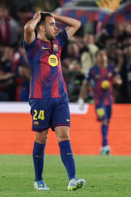 Barcelona's Spanish defender #24 Eric Garcia reacts after failing to score during the UEFA Champions League quarter final first leg football match between FC Barcelona and Club Atletico de Madrid at Camp Nou Stadium in Barcelona on April 8, 2026. (Photo by Lluis GENE / AFP)