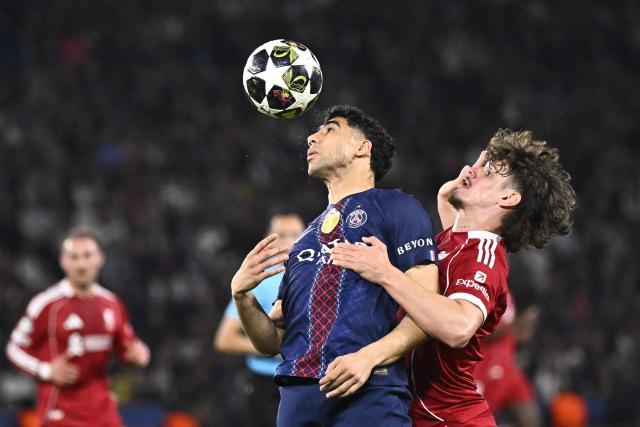 Liverpool's Hungarian defender #06 Milos Kerkez (R) fights for the ball with Paris Saint-Germain's Moroccan defender #02 Achraf Hakimi during the UEFA Champions League quarter-final first leg football match between Paris Saint-Germain (PSG) and Liverpool FC at the Parc des Princes stadium in Paris on April 8, 2026. (Photo by JULIEN DE ROSA / AFP)