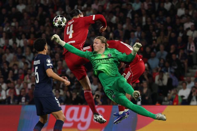 Paris Saint-Germain's Russian goalkeeper #39 Matvey Safonov (R) makes a save in front of Liverpool's Dutch defender #04 Virgil van Dijk during the UEFA Champions League quarter-final first leg football match between Paris Saint-Germain (PSG) and Liverpool FC at the Parc des Princes stadium in Paris on April 8, 2026. (Photo by Anne-Christine POUJOULAT / AFP)