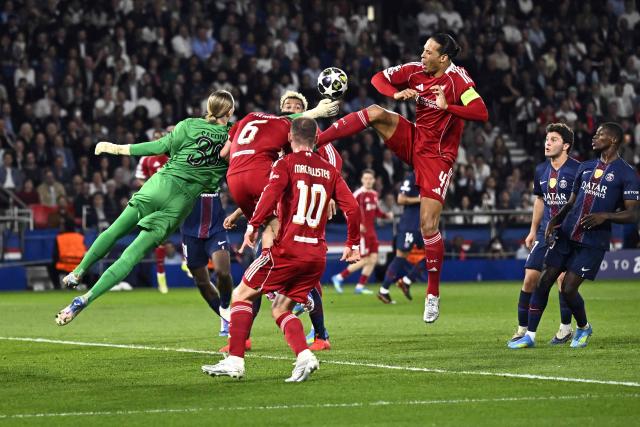 Paris Saint-Germain's Russian goalkeeper #39 Matvey Safonov (L) makes a save in front of Liverpool's Dutch defender #04 Virgil van Dijk during the UEFA Champions League quarter-final first leg football match between Paris Saint-Germain (PSG) and Liverpool FC at the Parc des Princes stadium in Paris on April 8, 2026. (Photo by JULIEN DE ROSA / AFP)