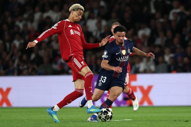 Liverpool's French striker #22 Hugo Ekitike (L) fights for the ball with Paris Saint-Germain's French midfielder #33 Warren Zaire-Emery during the UEFA Champions League quarter-final first leg football match between Paris Saint-Germain (PSG) and Liverpool FC at the Parc des Princes stadium in Paris on April 8, 2026. (Photo by Anne-Christine POUJOULAT / AFP)