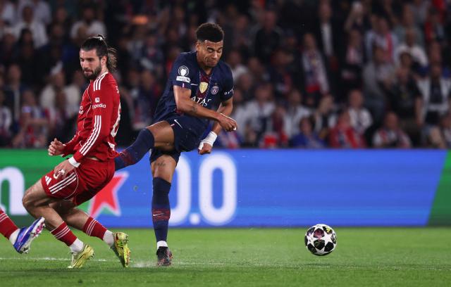 Paris Saint-Germain's French midfielder #14 Desire Doue (R) fights for the ball with Liverpool's Hungarian midfielder #08 Dominik Szoboszlai (L) during the UEFA Champions League quarter-final first leg football match between Paris Saint-Germain (PSG) and Liverpool FC at the Parc des Princes stadium in Paris on April 8, 2026. (Photo by FRANCK FIFE / AFP)