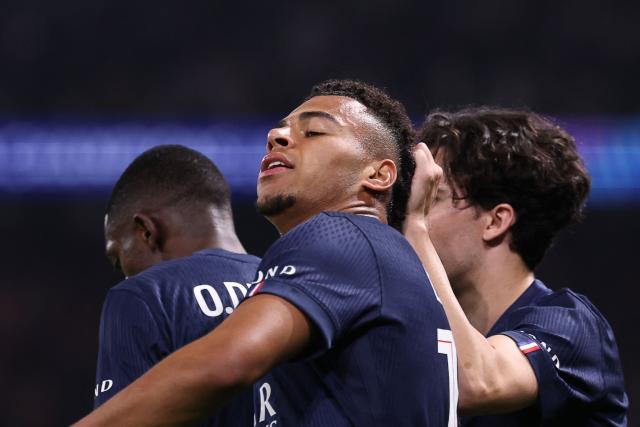 Paris Saint-Germain's French midfielder #14 Desire Doue (C) celebrates with teammates after scoring the opening goal during the UEFA Champions League quarter-final first leg football match between Paris Saint-Germain (PSG) and Liverpool FC at the Parc des Princes stadium in Paris on April 8, 2026. (Photo by FRANCK FIFE / AFP)