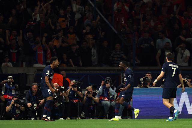 Paris Saint-Germain's French midfielder #14 Desire Doue (L) celebrates with Paris Saint-Germain's French forward #10 Ousmane Dembele after scoring his team's first goal during the UEFA Champions League quarter-final first leg football match between Paris Saint-Germain (PSG) and Liverpool FC at the Parc des Princes stadium in Paris on April 8, 2026. (Photo by Anne-Christine POUJOULAT / AFP)