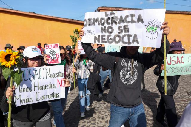 Protesters denouncing an allegedly illegal election gather outside the venue where authorities of the public University of San Carlos meet to appoint their rector, in Antigua, Guatemala, on April 8, 2026. The reelection of the rector of Guatemala's sole public university ended in gunfire and unrest outside a luxury hotel where the vote was held, which the OAS described as a "tainted process." (Photo by Christian Gutierrez / AFP)