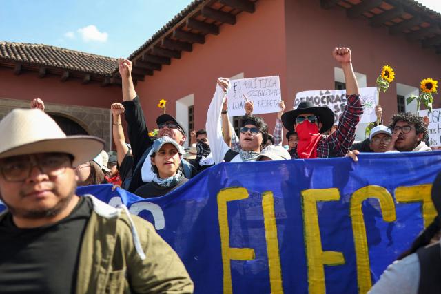 Protesters denouncing an allegedly illegal election gather outside the venue where authorities of the public University of San Carlos meet to appoint their rector, in Antigua, Guatemala, on April 8, 2026. The reelection of the rector of Guatemala's sole public university ended in gunfire and unrest outside a luxury hotel where the vote was held, which the OAS described as a "tainted process." (Photo by Christian Gutierrez / AFP)