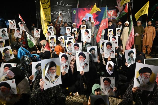 Shiite Muslims hold portraits of Iran's supreme leaders, Ali Hosseini Khamenei and his son Mojtaba Khamenei as they celebrate after the United States and Iran agreed to a two-week ceasefire in Karachi on April 8, 2026. Pakistan's Prime Minister Shehbaz Sharif said on April 8, 2026, that Islamabad would host delegations from the United States and Iran later this week following their ceasefire announcement. (Photo by Asif HASSAN / AFP)