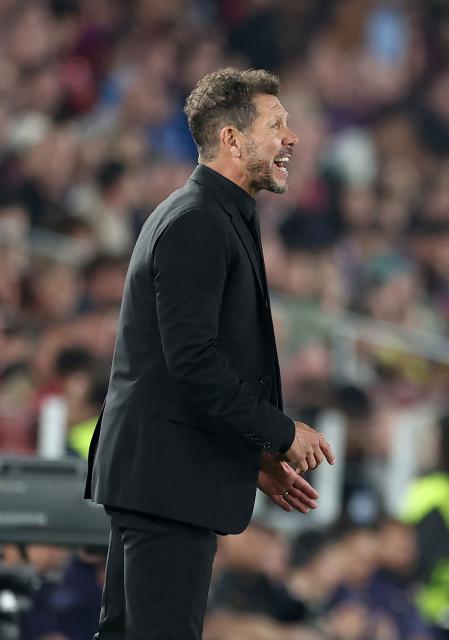 Atletico Madrid's Argentine coach Diego Simeone gestures on the touchline during the UEFA Champions League quarter final first leg football match between FC Barcelona and Club Atletico de Madrid at Camp Nou Stadium in Barcelona on April 8, 2026. (Photo by Josep LAGO / AFP)