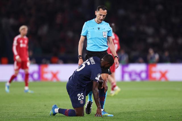 Paris Saint-Germain's Portuguese defender #25 Nuno Mendes (down) reacts next to Spanish referee Jose Maria Sanchez during the  UEFA Champions League quarter-final first leg football match between Paris Saint-Germain (PSG) and Liverpool FC at the Parc des Princes stadium in Paris on April 8, 2026. (Photo by FRANCK FIFE / AFP)