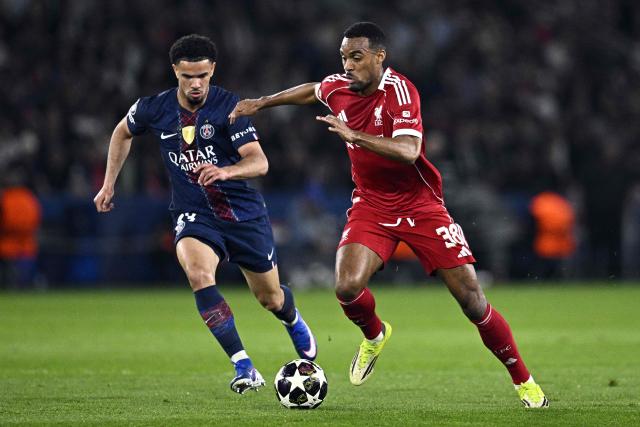 Liverpool's Dutch midfielder #38 Ryan Gravenberch (R) fights for the ball with Paris Saint-Germain's French midfielder #33 Warren Zaire-Emery during the UEFA Champions League quarter-final first leg football match between Paris Saint-Germain (PSG) and Liverpool FC at the Parc des Princes stadium in Paris on April 8, 2026. (Photo by JULIEN DE ROSA / AFP)