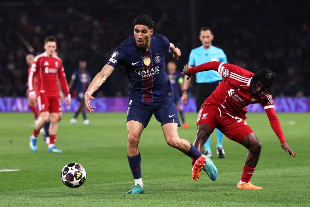 Morocco's defender #02 Achraf Hakimi (L) fights for the ball with Liverpool's Dutch defender #30 Jeremie Frimpong  during the UEFA Champions League quarter-final first leg football match between Paris Saint-Germain (PSG) and Liverpool FC at the Parc des Princes stadium in Paris on April 8, 2026. (Photo by FRANCK FIFE / AFP)
