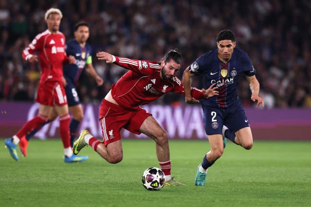 Liverpool's Hungarian midfielder #08 Dominik Szoboszlai (C) fights for the ball with Paris Saint-Germain's Moroccan defender #02 Achraf Hakimi (R)  during the UEFA Champions League quarter-final first leg football match between Paris Saint-Germain (PSG) and Liverpool FC at the Parc des Princes stadium in Paris on April 8, 2026. (Photo by FRANCK FIFE / AFP)