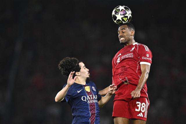 Liverpool's Dutch midfielder #38 Ryan Gravenberch (R) heads the ball in front of Paris Saint-Germain's Portuguese midfielder #17 Vitinha during the UEFA Champions League quarter-final first leg football match between Paris Saint-Germain (PSG) and Liverpool FC at the Parc des Princes stadium in Paris on April 8, 2026. (Photo by JULIEN DE ROSA / AFP)