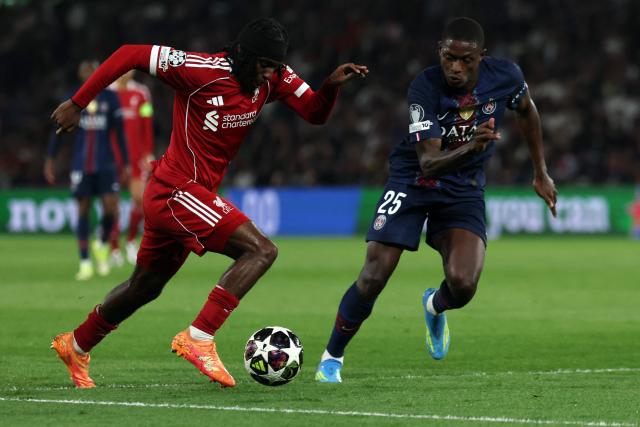 Liverpool's Dutch defender #30 Jeremie Frimpong (L) fights for the ball with Paris Saint-Germain's Portuguese defender #25 Nuno Mendes during the UEFA Champions League quarter-final first leg football match between Paris Saint-Germain (PSG) and Liverpool FC at the Parc des Princes stadium in Paris on April 8, 2026. (Photo by Anne-Christine POUJOULAT / AFP)