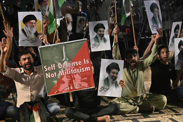 Shiite Muslims hold portraits of Iran's supreme leaders, Ali Hosseini Khamenei and his son Mojtaba Khamenei as they celebrate after the United States and Iran agreed to a two-week ceasefire in Karachi on late April 8, 2026. Pakistan's Prime Minister Shehbaz Sharif said on April 8, 2026, that Islamabad would host delegations from the United States and Iran later this week following their ceasefire announcement. (Photo by Asif HASSAN / AFP)