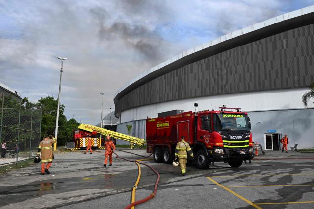 Firefighters work to extinguish a fire at the Olympic Velodrome in Rio de Janeiro, Brazil, on April 8, 2026. According to city authorities, the velodrome suffered limited damage and no injuries were reported, while the Rio Olympic Museum and its historical collection from the 2016 Olympic Games remained intact. (Photo by Pablo PORCIUNCULA / AFP)
