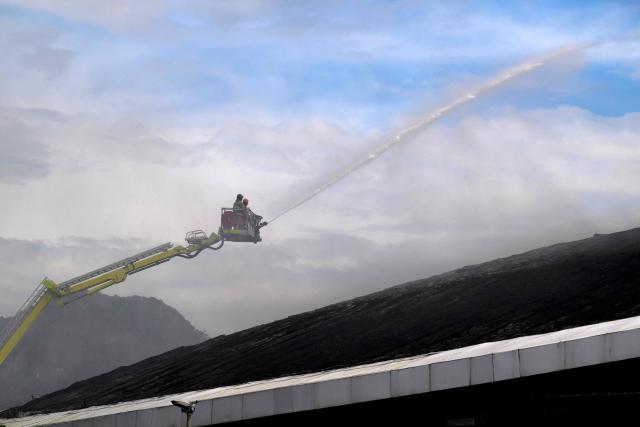 Firefighters work to extinguish a fire at the Olympic Velodrome in Rio de Janeiro, Brazil, on April 8, 2026. According to city authorities, the velodrome suffered limited damage and no injuries were reported, while the Rio Olympic Museum and its historical collection from the 2016 Olympic Games remained intact. (Photo by Pablo PORCIUNCULA / AFP)